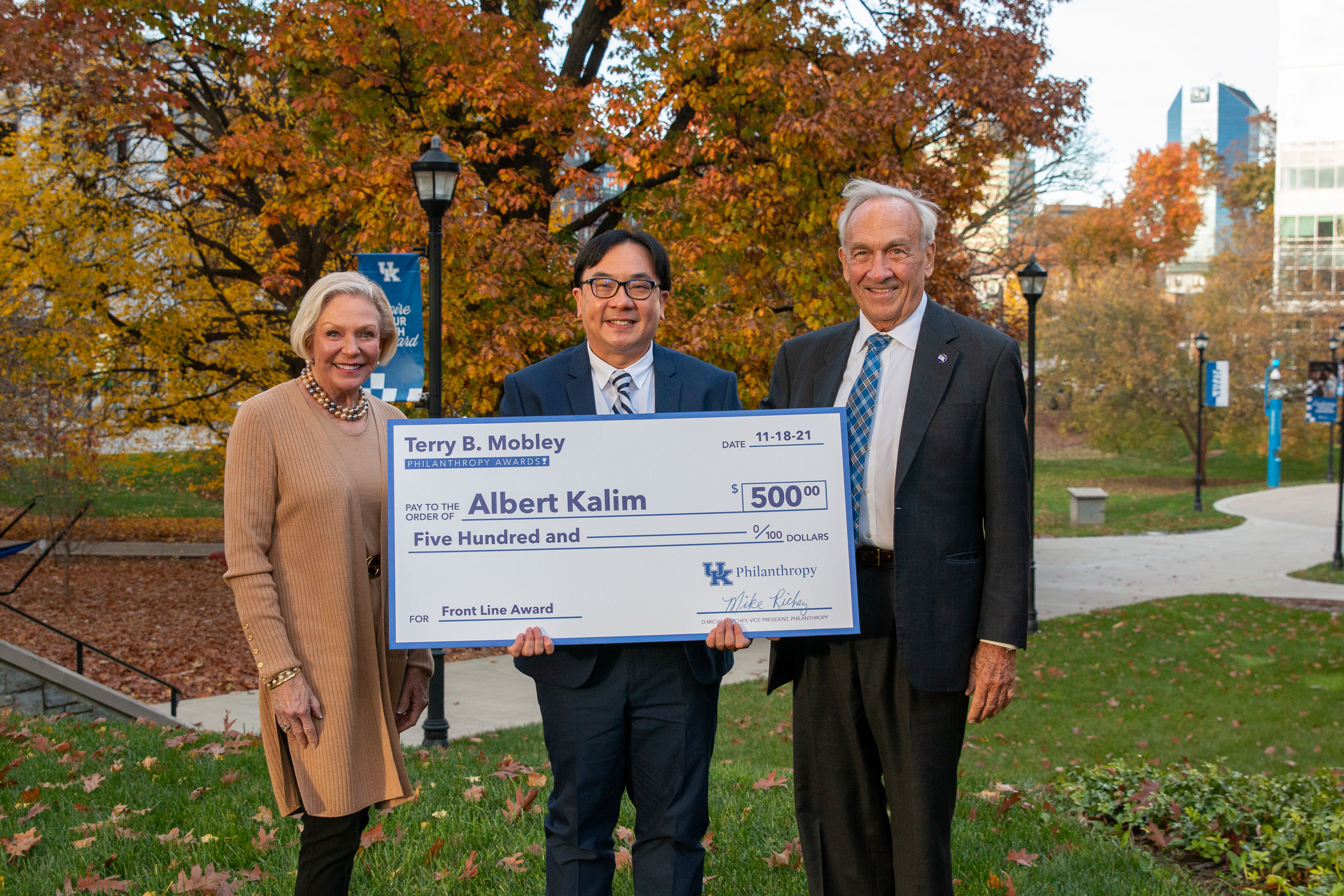 Albert Kalim holding his mobley award check in November 2021