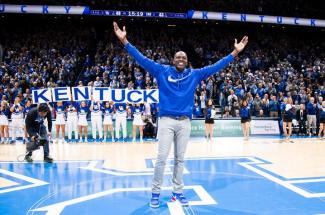 Tony Delk standing on basketball court