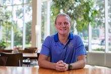 Photo of Tanner Thomspon seated and smiling